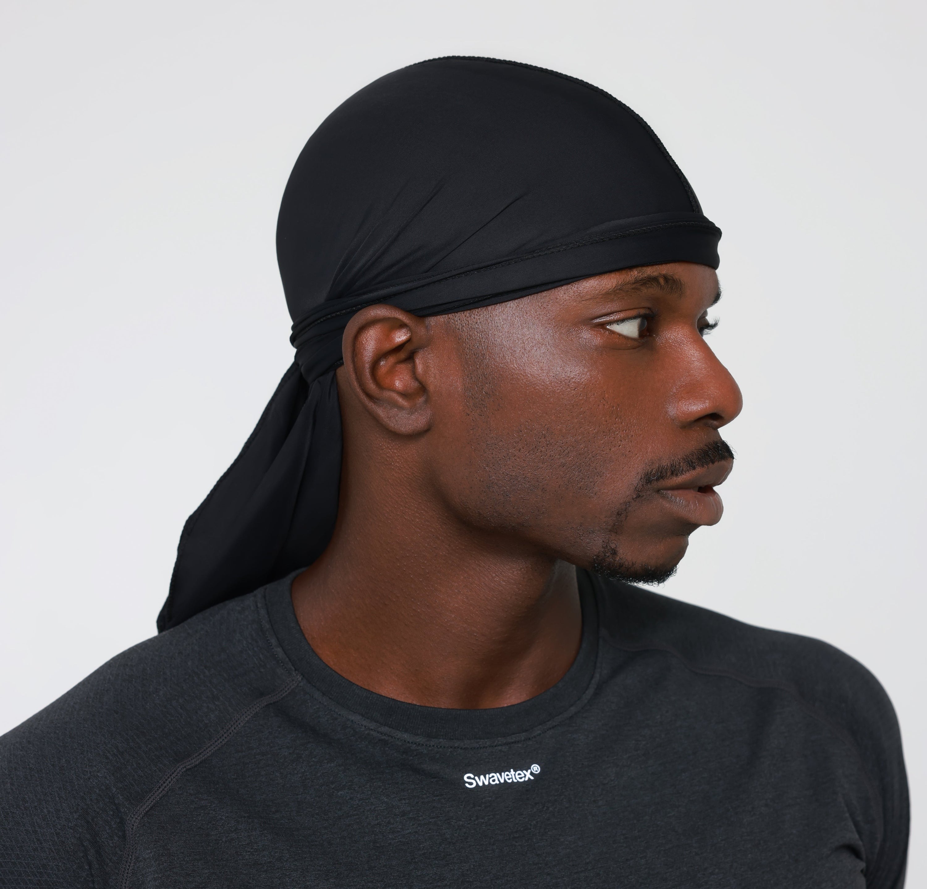 Swavetex black satin durag worn by male model, full durag down to the Swavetex logo on the shirt