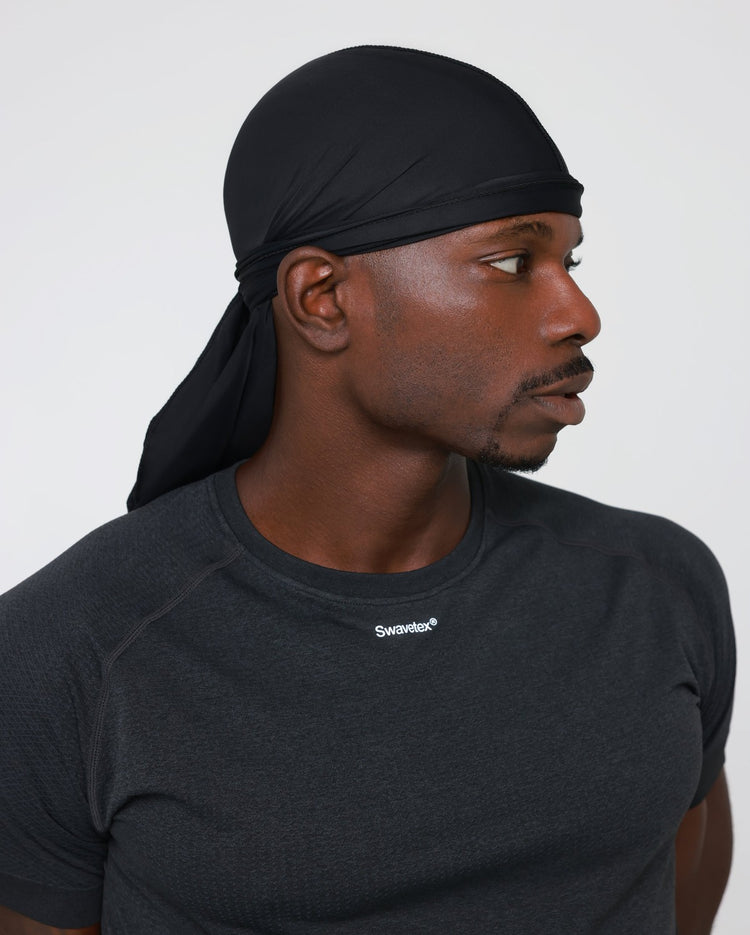 Swavetex black satin durag worn by male model, shown from the full durag down to the Swavetex logo on the shirt